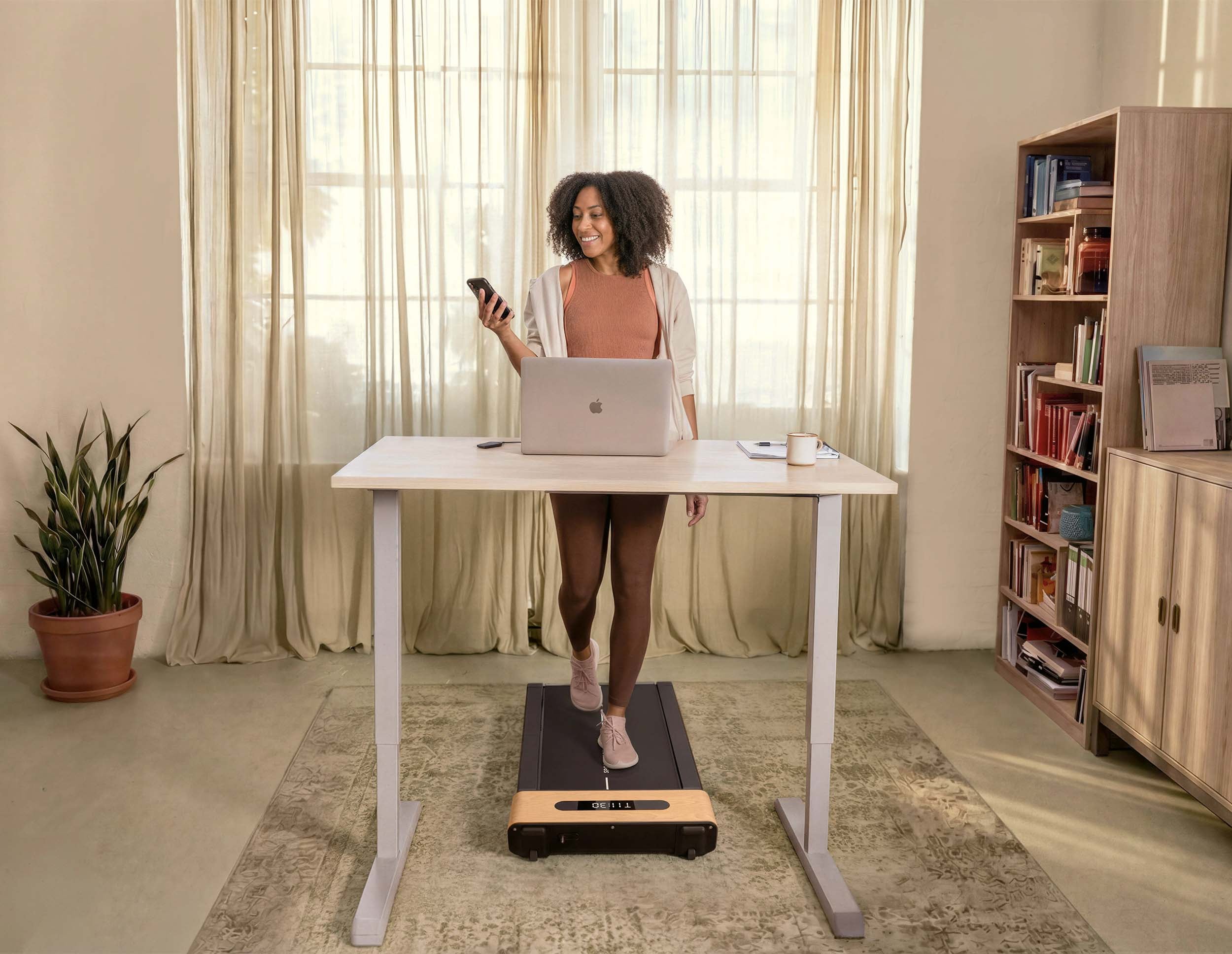 Home office with standing desk and treadmill